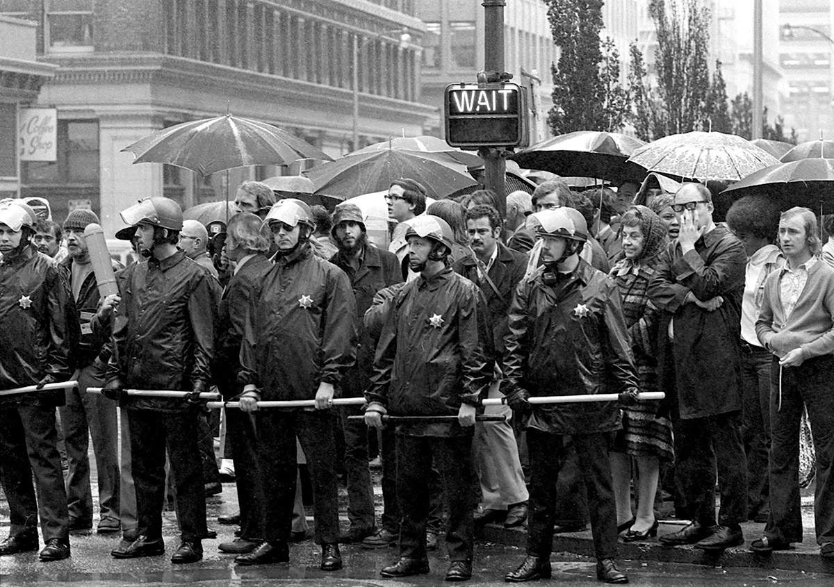 Police maintaining order as pedestrians wait. San Francisco, 1972.